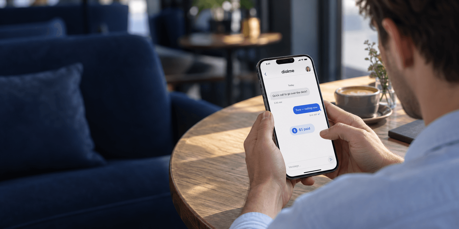 Someone using the DialMe messaging interface on an iPhone in a café